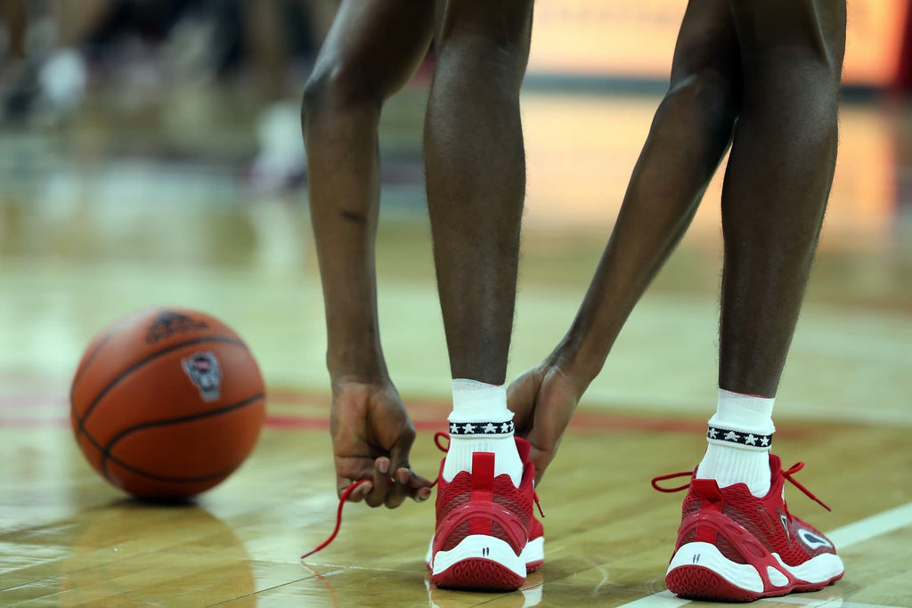 Basketball Player Tying His Shoes
